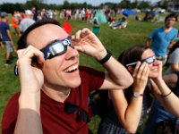Bill Hillman and wife Caroline Jelmi join the crowd gathered in front of the UMass Dartmouth observatory to view the partial solar eclipse that swept over the area.   [ PETER PEREIRA/THE STANDARD-TIMES/SCMG ]